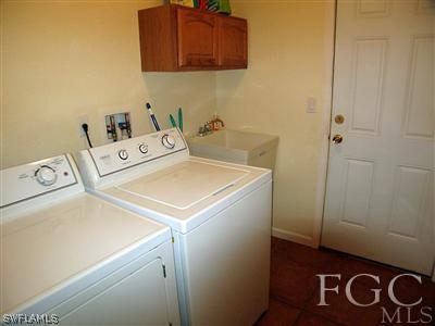 10683 Holly Road Bokeelia, FL 33922 - Photo 8 of 10 a utility room with dryer and washer