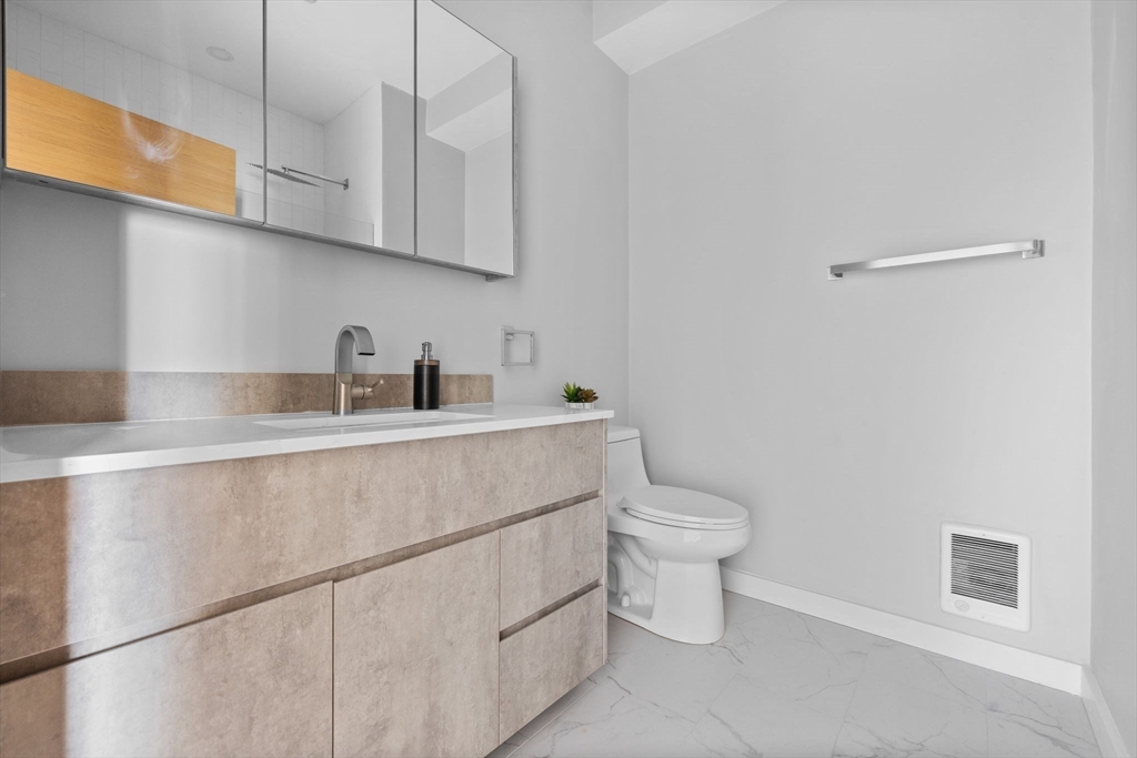 33 Copeland Street, Unit C Boston, MA 02119 - Photo 13 of 23 a kitchen with a sink a toilet and cabinets