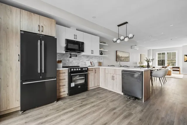 a kitchen with granite countertop a refrigerator oven a sink dishwasher and a stove with wooden floor