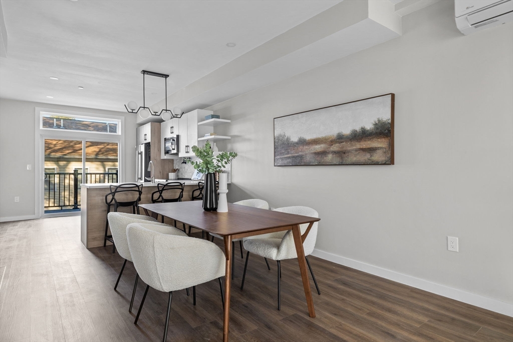 33 Copeland Street, Unit C Boston, MA 02119 - Photo 5 of 23 a view of a dining room with furniture wooden floor and chandelier