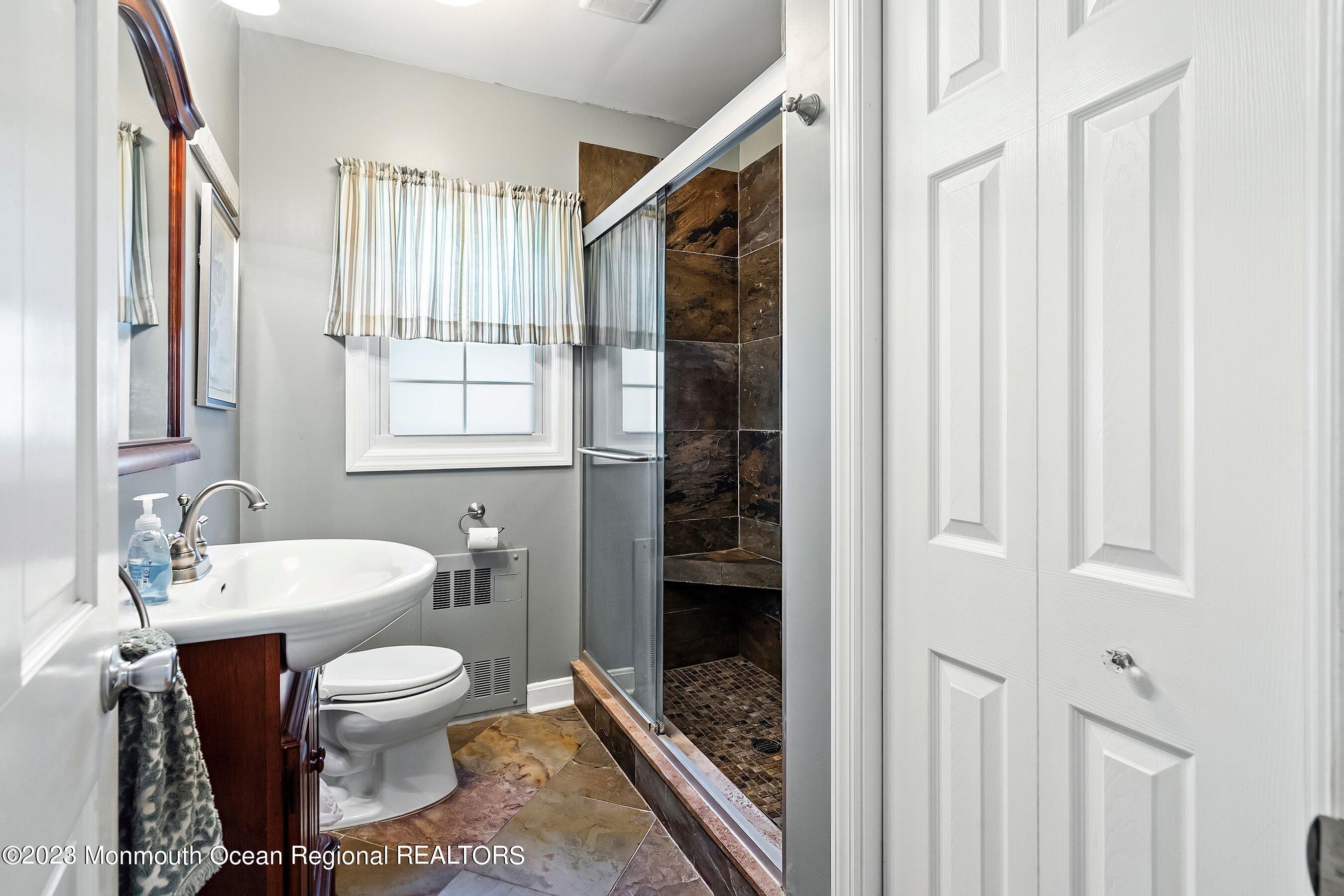 154 Adelphia Road Farmingdale, NJ 07727 - Photo 17 of 34 a bathroom with a toilet a sink and shower