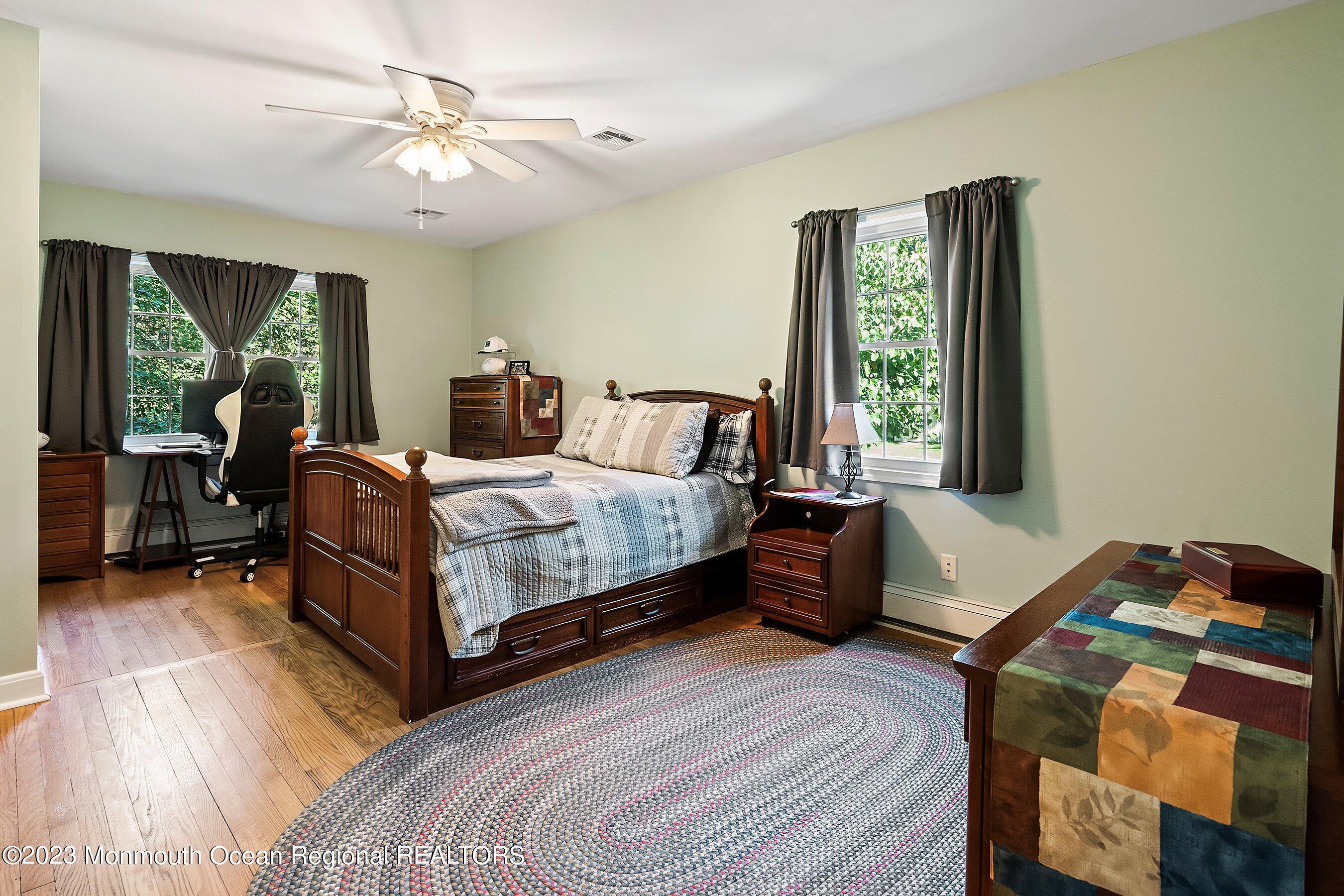 154 Adelphia Road Farmingdale, NJ 07727 - Photo 19 of 34 a bedroom with a bed and a chandelier
