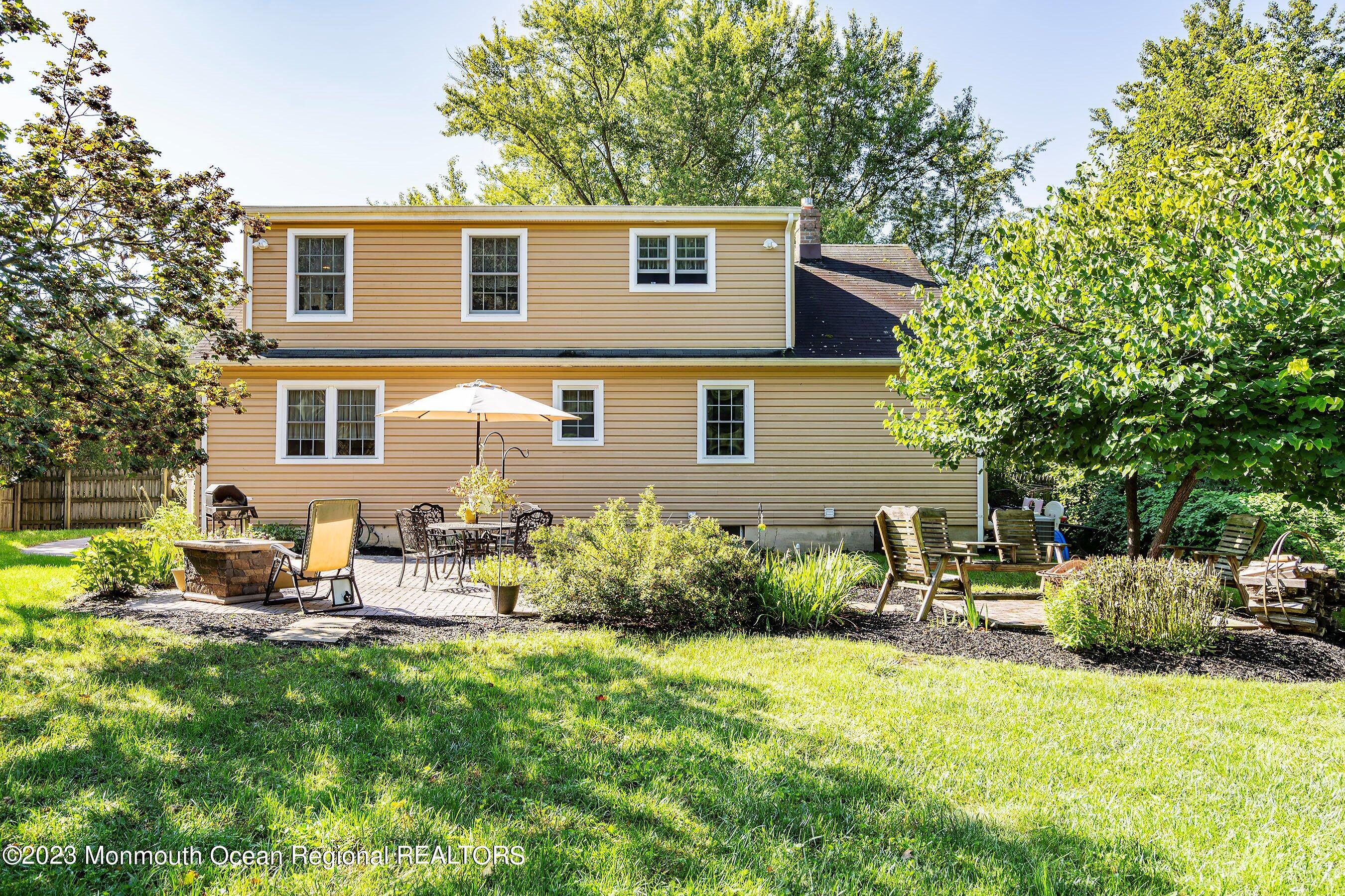 154 Adelphia Road Farmingdale, NJ 07727 - Photo 33 of 34 a view of backyard of house with outdoor seating and green space
