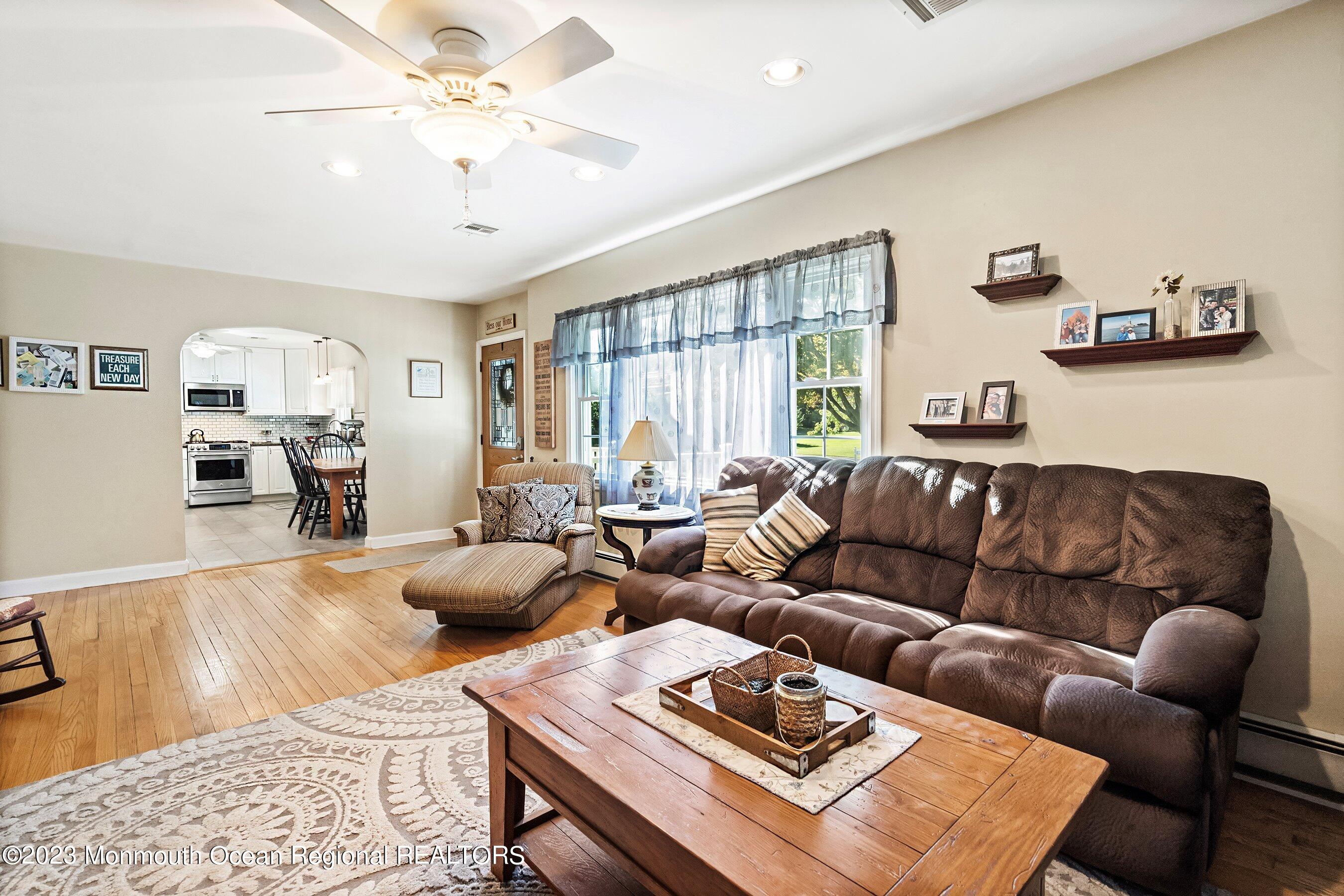 154 Adelphia Road Farmingdale, NJ 07727 - Photo 8 of 34 a living room with furniture ceiling fan and a rug