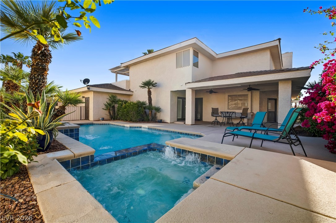 1135 Calico Ridge Drive Henderson, NV 89011 - Photo 53 of 86 An inviting backyard oasis awaits with a sparkling pool and spa, perfect for outdoor relaxation and entertainment.