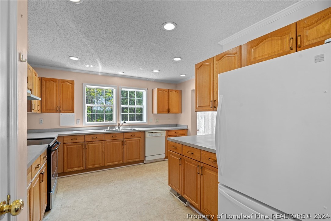 140 Ridge View Drive Cameron, NC 28326 - Photo 15 of 42 a kitchen with a sink stove and cabinets