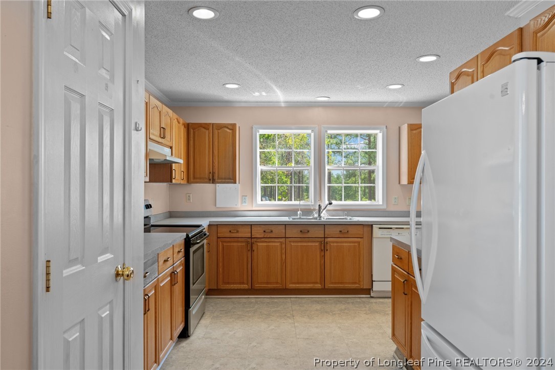 140 Ridge View Drive Cameron, NC 28326 - Photo 16 of 42 a kitchen with a sink stove and cabinets