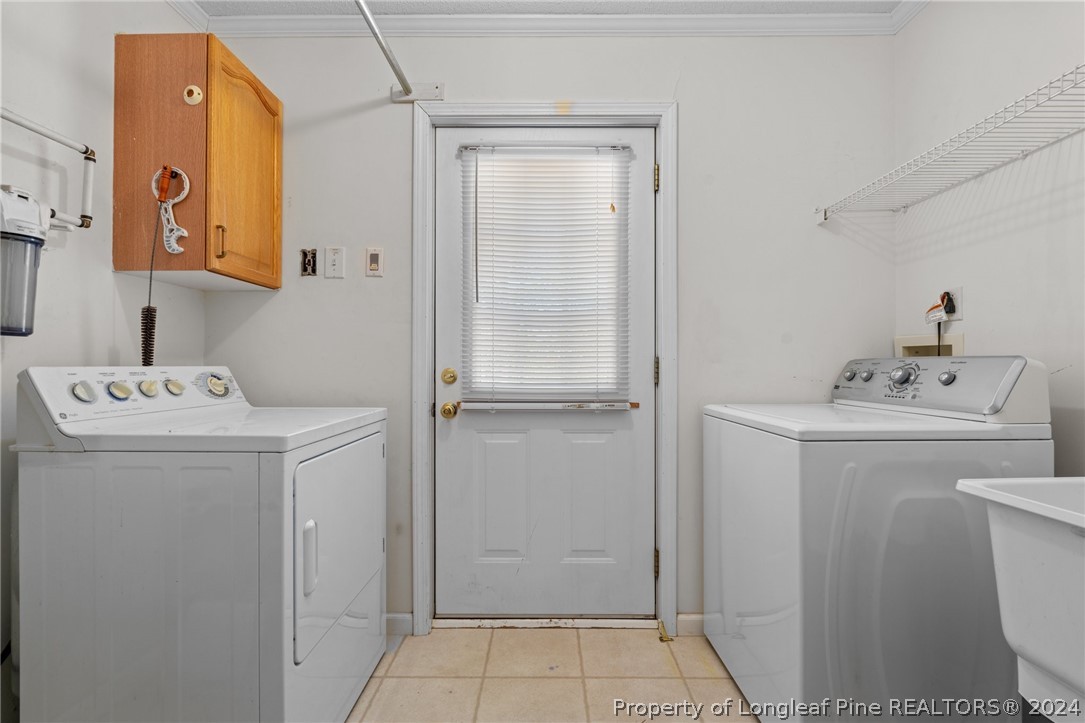 140 Ridge View Drive Cameron, NC 28326 - Photo 20 of 42 a utility room with cabinets washer and dryer