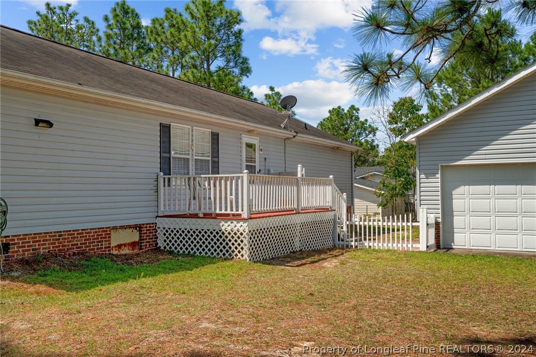 140 Ridge View Drive Cameron, NC 28326 - Photo 34 of 42 a backyard of a house with a garden and deck