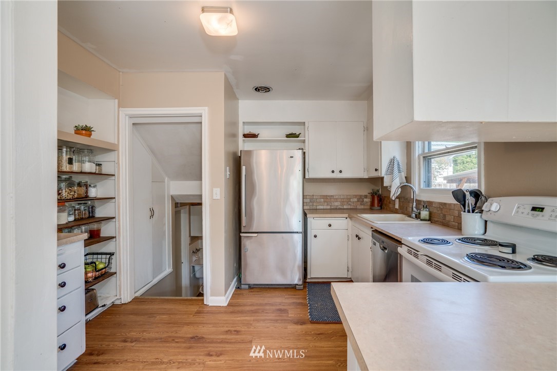 1036 Tyler Street Wenatchee, WA 98801 - Photo 13 of 29 a kitchen with stainless steel appliances a refrigerator sink and cabinets