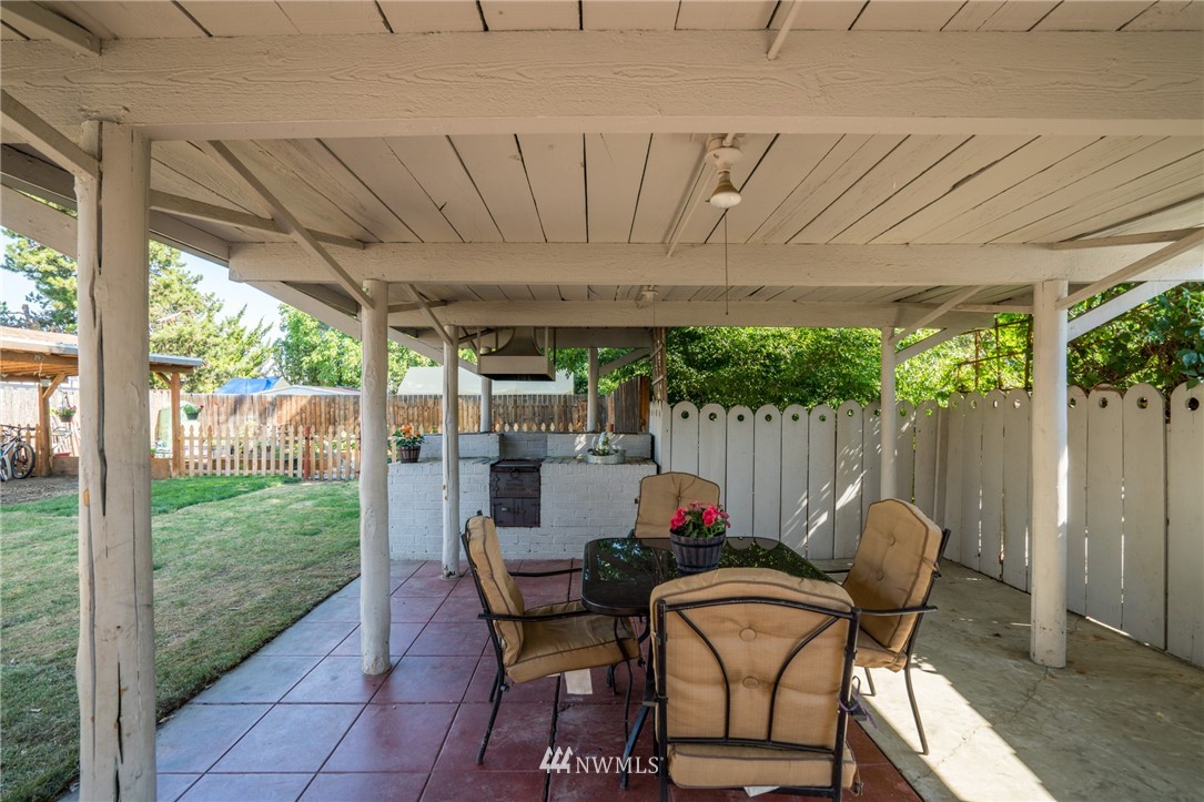 1036 Tyler Street Wenatchee, WA 98801 - Photo 24 of 29 a view of a patio with table and chairs potted plants with wooden floor