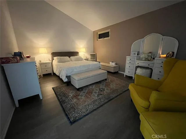 a bedroom with bed couch and window