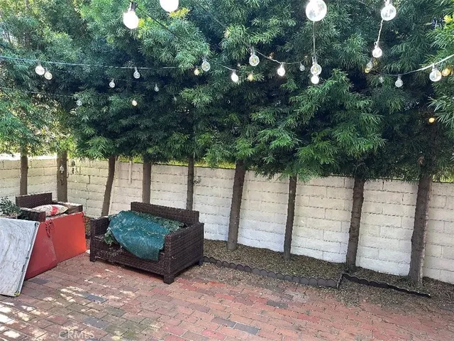 a backyard of a house with barbeque oven and outdoor seating