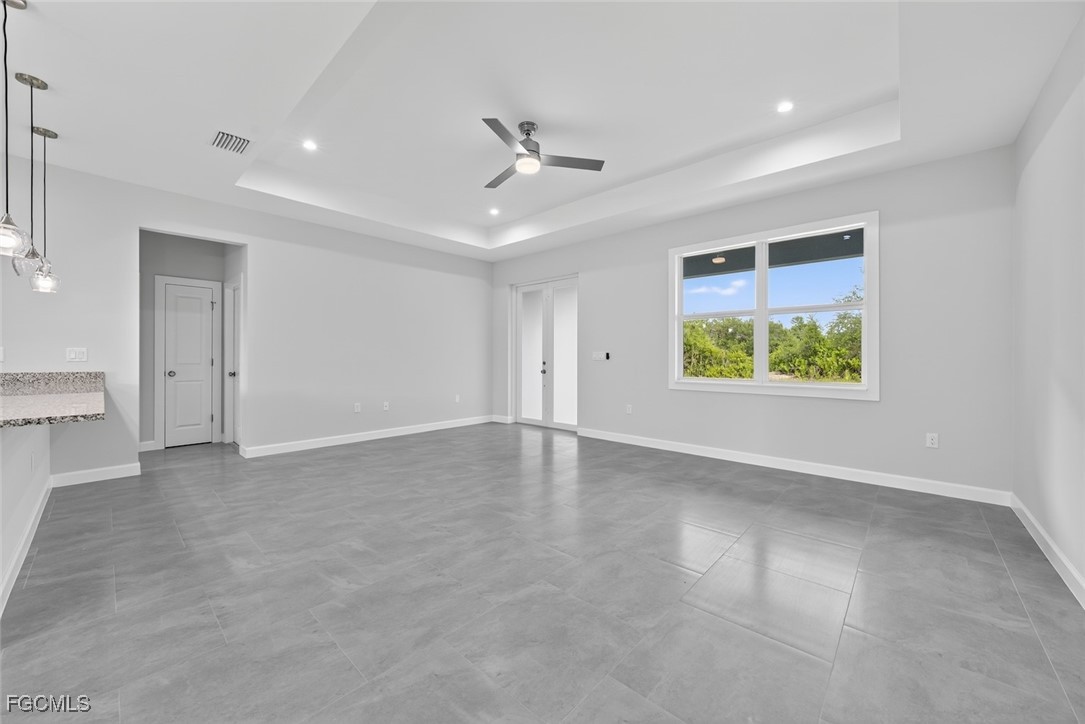 2864 68th Avenue Northeast Naples, FL 34120 - Photo 14 of 47 an empty room with windows and ceiling fan
