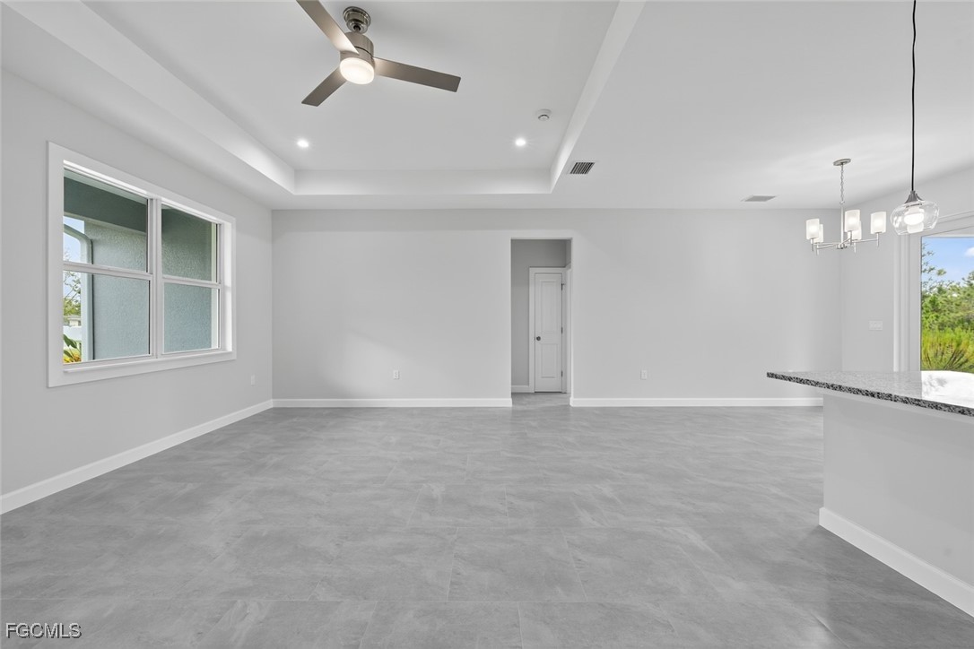 2864 68th Avenue Northeast Naples, FL 34120 - Photo 16 of 47 en empty room with windows and ceiling fan