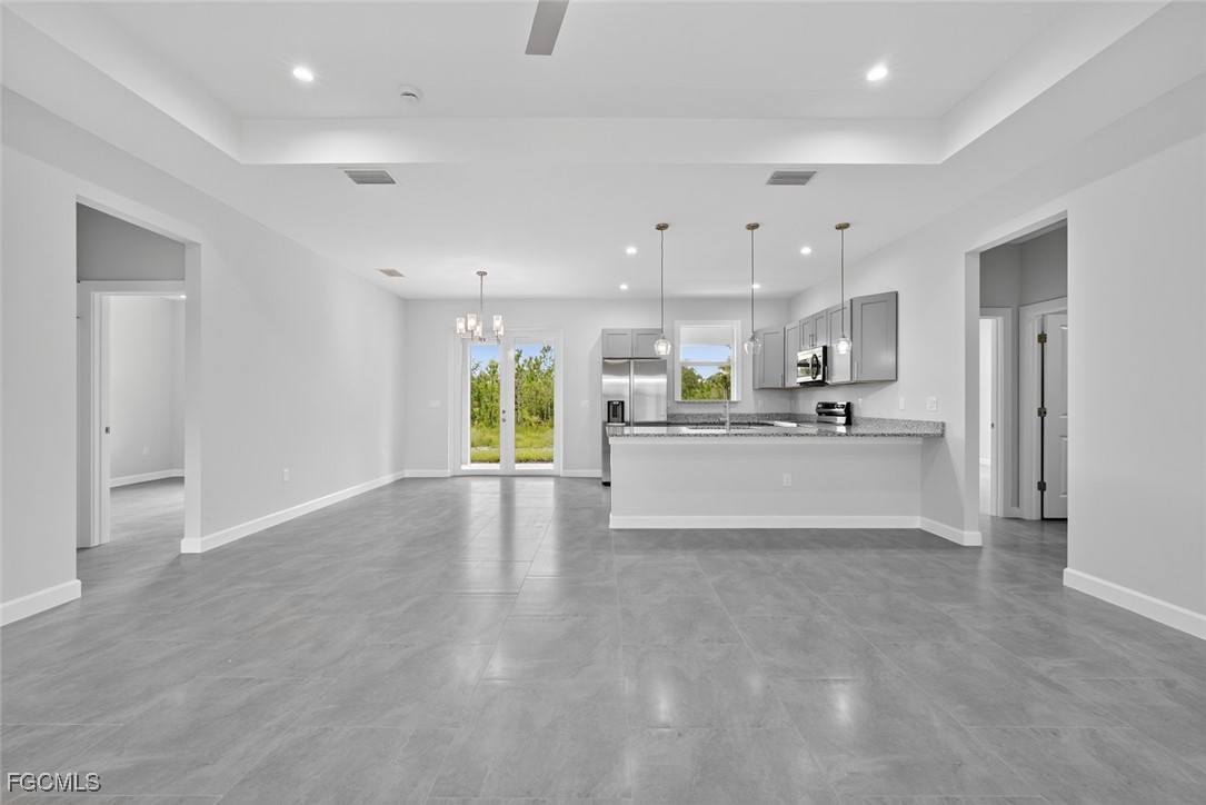 2864 68th Avenue Northeast Naples, FL 34120 - Photo 18 of 47 a view of a kitchen with kitchen island a sink stainless steel appliances and cabinets