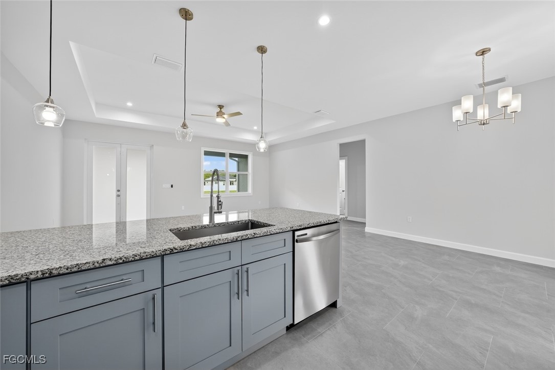 2864 68th Avenue Northeast Naples, FL 34120 - Photo 22 of 47 a kitchen with kitchen island granite countertop stainless steel appliances sink and white cabinets