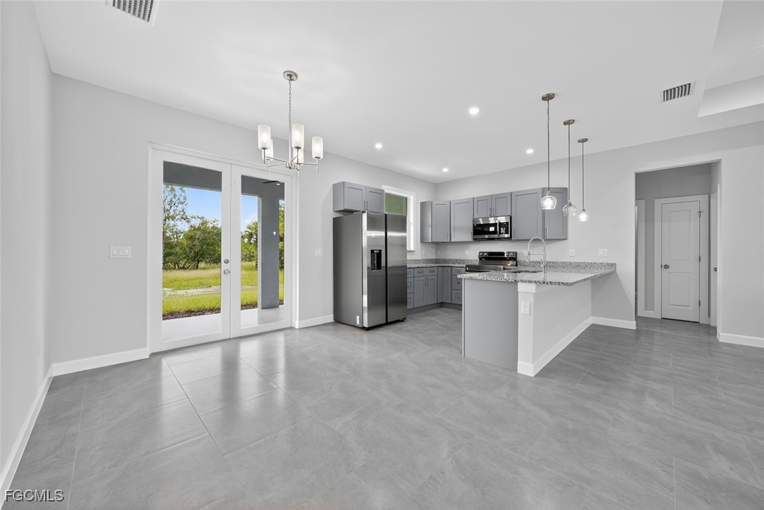 2864 68th Avenue Northeast Naples, FL 34120 - Photo 25 of 47 a view of a kitchen with stainless steel appliances granite countertop a large counter top a sink and a refrigerator