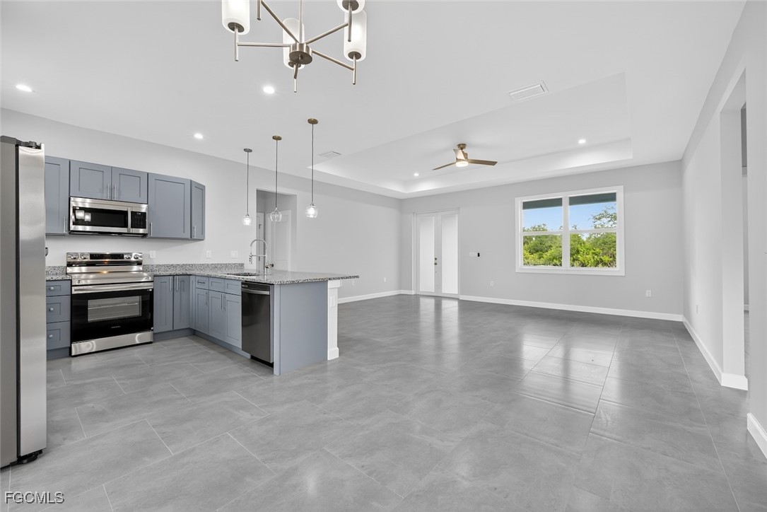 2864 68th Avenue Northeast Naples, FL 34120 - Photo 26 of 47 a kitchen with a stove a sink and a microwave