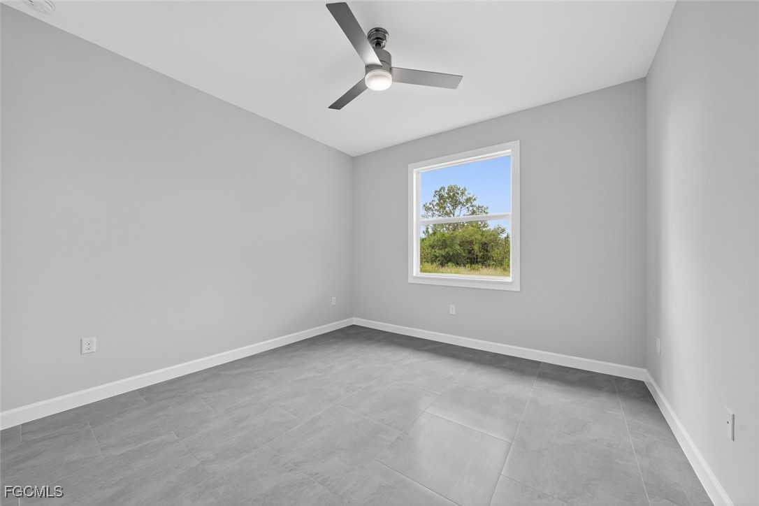 2864 68th Avenue Northeast Naples, FL 34120 - Photo 37 of 47 an empty room with a window and a ceiling fan