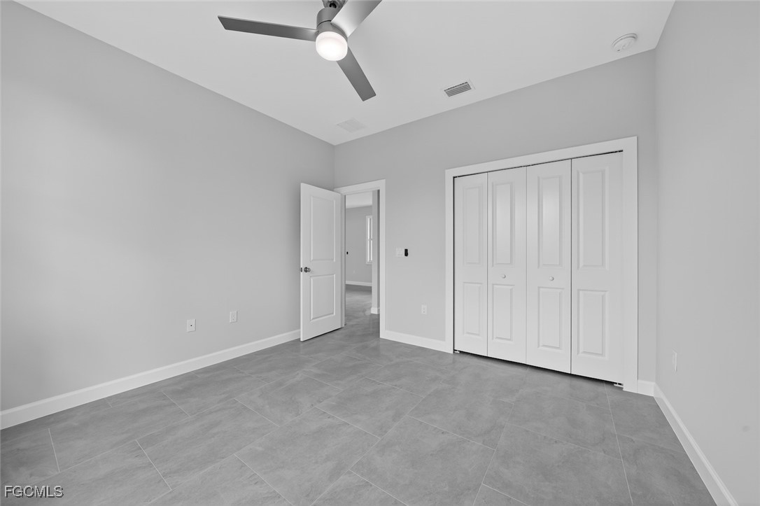 2864 68th Avenue Northeast Naples, FL 34120 - Photo 38 of 47 a view of an empty room and a ceiling fan