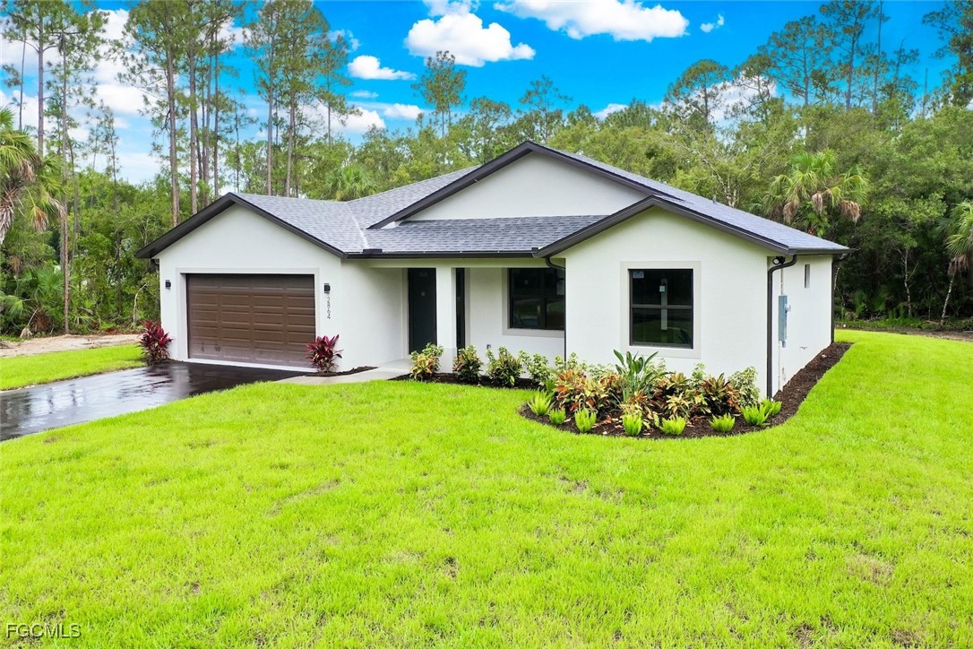 2864 68th Avenue Northeast Naples, FL 34120 - Photo 4 of 47 a front view of house with yard and green space
