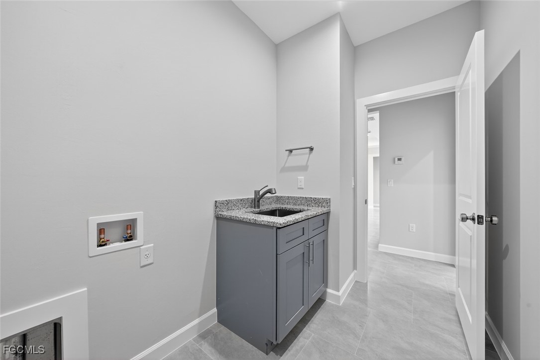 2864 68th Avenue Northeast Naples, FL 34120 - Photo 41 of 47 a kitchen with sink stove and cabinets