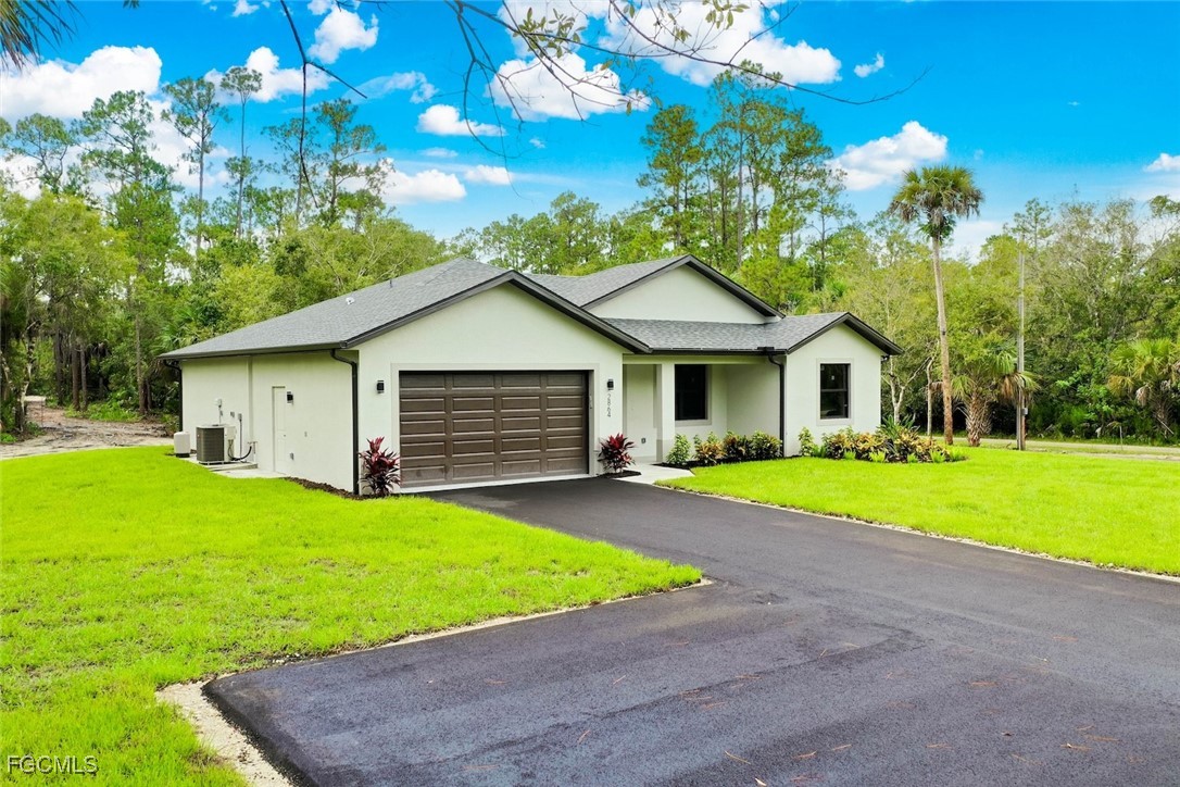 2864 68th Avenue Northeast Naples, FL 34120 - Photo 5 of 47 a view of a house with a yard and tree