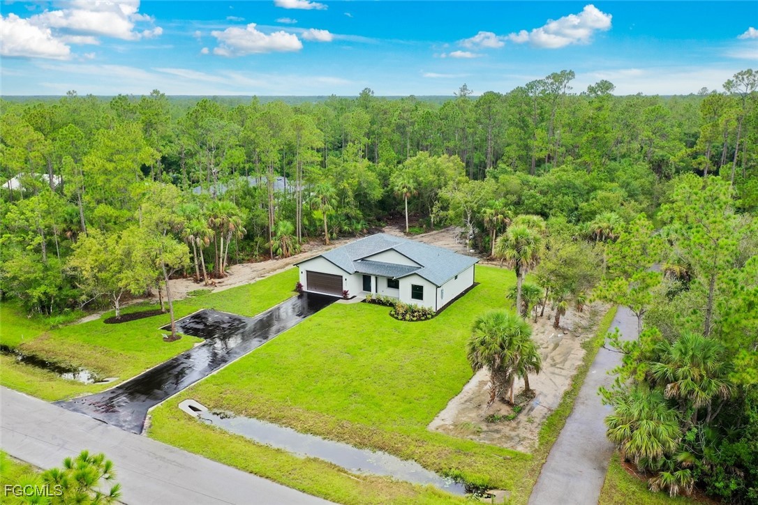2864 68th Avenue Northeast Naples, FL 34120 - Photo 7 of 47 an aerial view of a house with pool large trees and yard