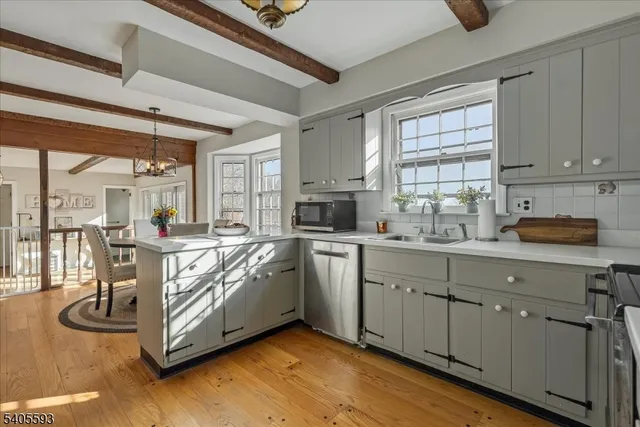 a kitchen with stainless steel appliances granite countertop a stove and cabinets