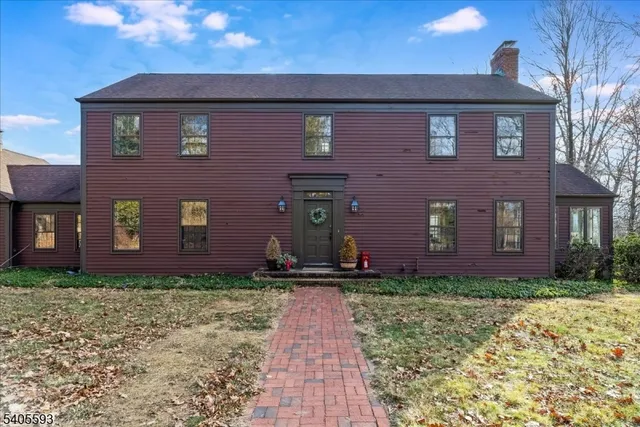 a front view of house with yard and trees