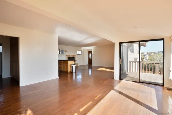 a view of a big room with wooden floor and a fireplace