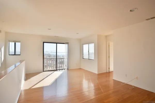 a view of a room with wooden floor and cabinet