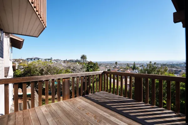 a balcony with wooden floor and fence