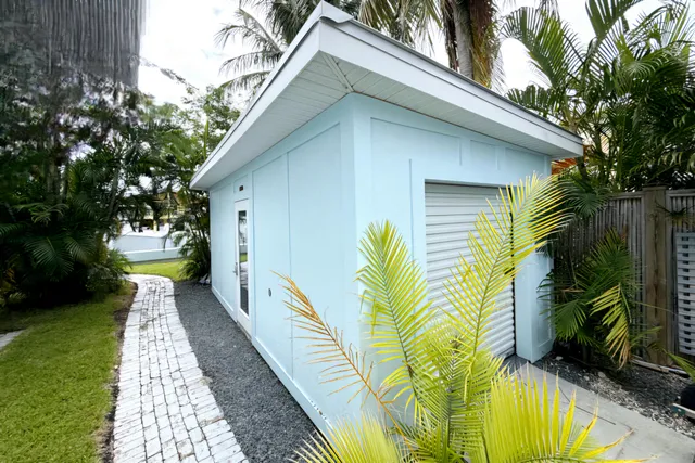 an aerial view of a house with swimming pool and a yard