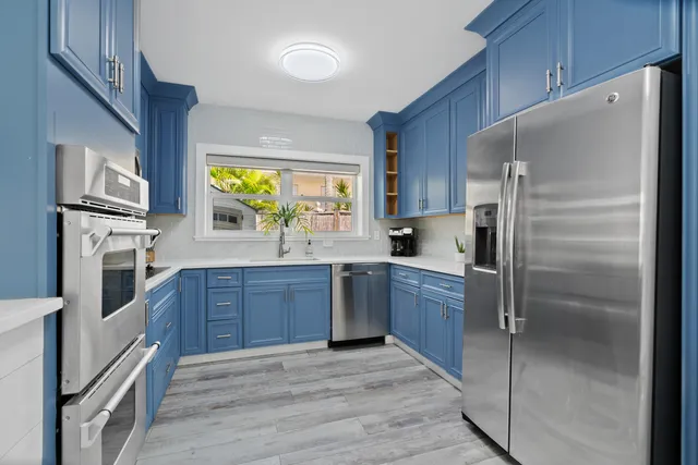 a kitchen with granite countertop wooden cabinets and stainless steel appliances
