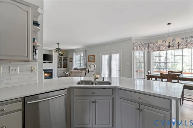 a kitchen with cabinets a center island and a window