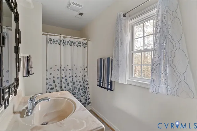 a bathroom with a sink a bathtub and a shower