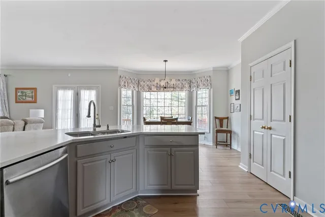 a kitchen with sink cabinets and wooden floor