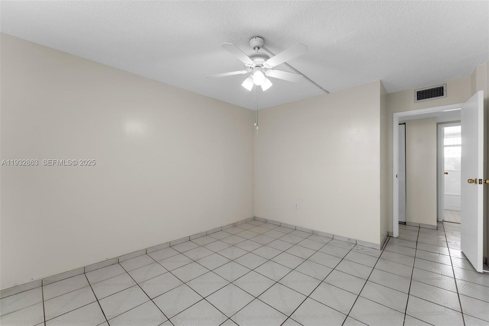14180 Southwest 84th Street, Unit 508G Miami, FL 33183 - Photo 14 of 32 a view of an empty room and chandelier fan
