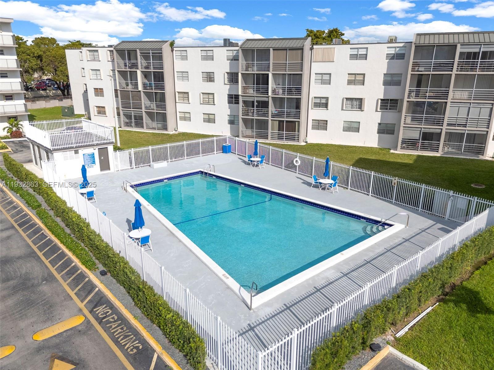 14180 Southwest 84th Street, Unit 508G Miami, FL 33183 - Photo 31 of 32 a view of a swimming pool with a lounge chairs