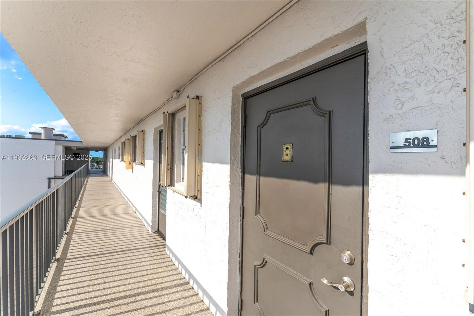 14180 Southwest 84th Street, Unit 508G Miami, FL 33183 - Photo 4 of 32 a view of a hallway with wooden floor and staircase