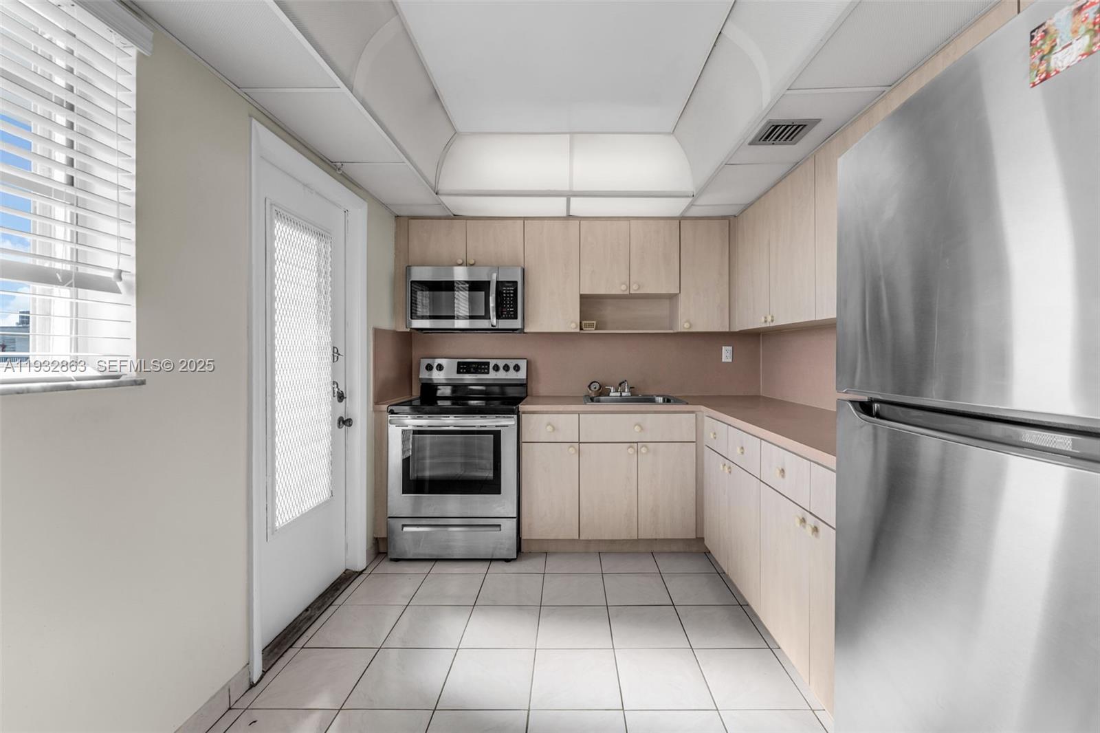 14180 Southwest 84th Street, Unit 508G Miami, FL 33183 - Photo 9 of 32 a kitchen with white cabinets and white appliances