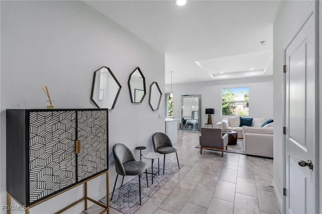a living room with furniture a table and white walls