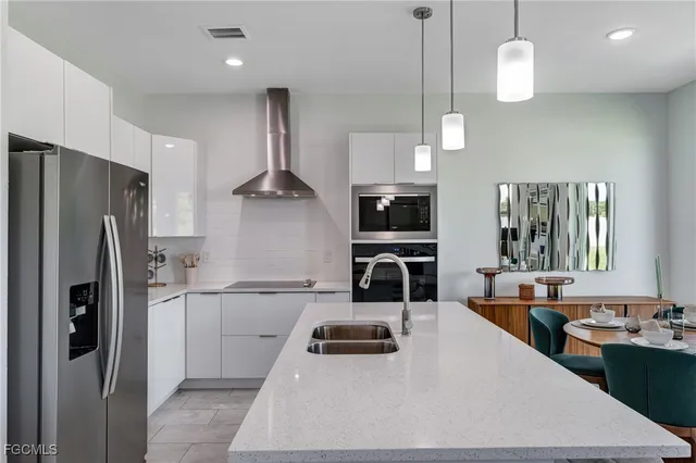 a kitchen with stainless steel appliances a stove a refrigerator and cabinets