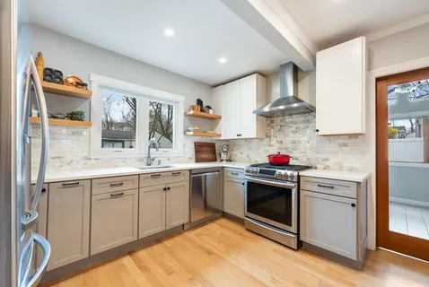 a kitchen with stainless steel appliances granite countertop a sink and cabinets
