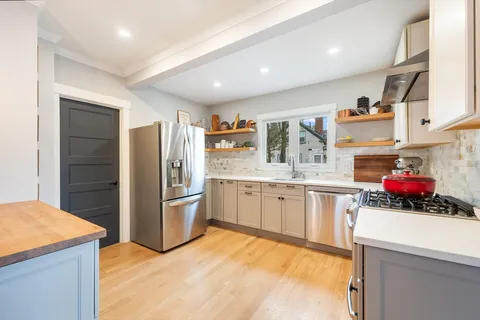 a kitchen with refrigerator and cabinets