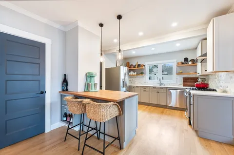 a kitchen that has a cabinets counter space and wooden floor