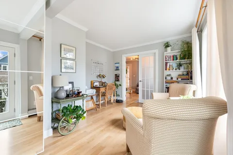 a bedroom with furniture and a large window