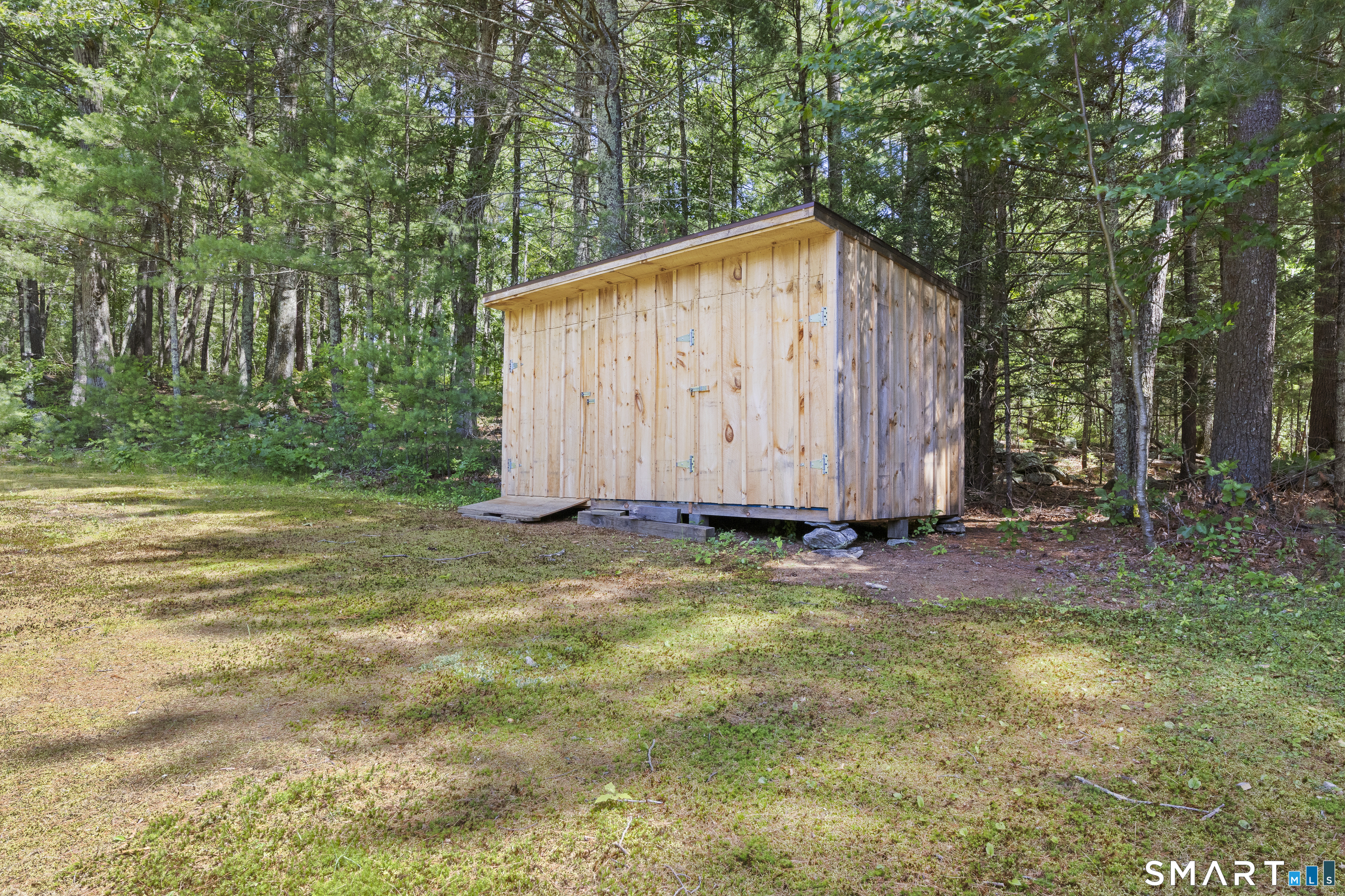 11 Munyan Road Putnam, CT 06260 - Photo 25 of 33 a backyard of a house with plants and large trees